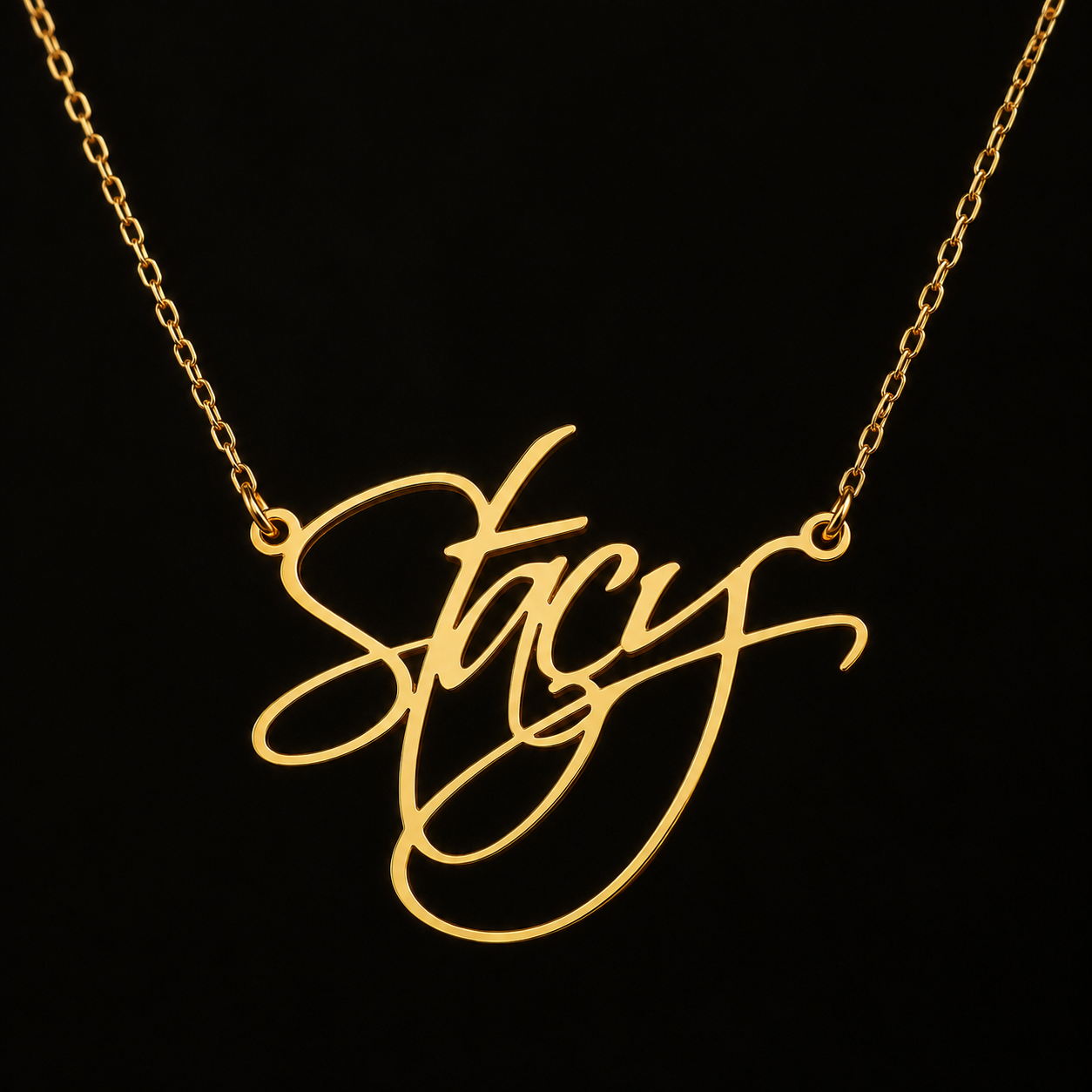 18K gold-plated script name necklace displayed on a black background