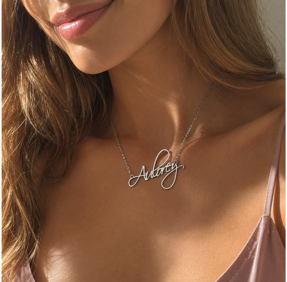 Close-up of woman wearing a custom silver Flame Script name necklace