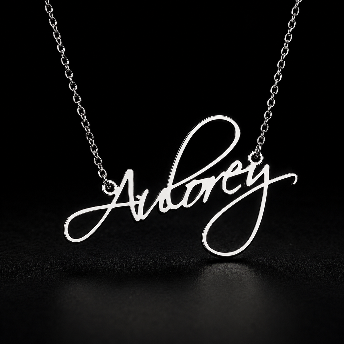Personalised silver Flame Script name necklace on black fabric